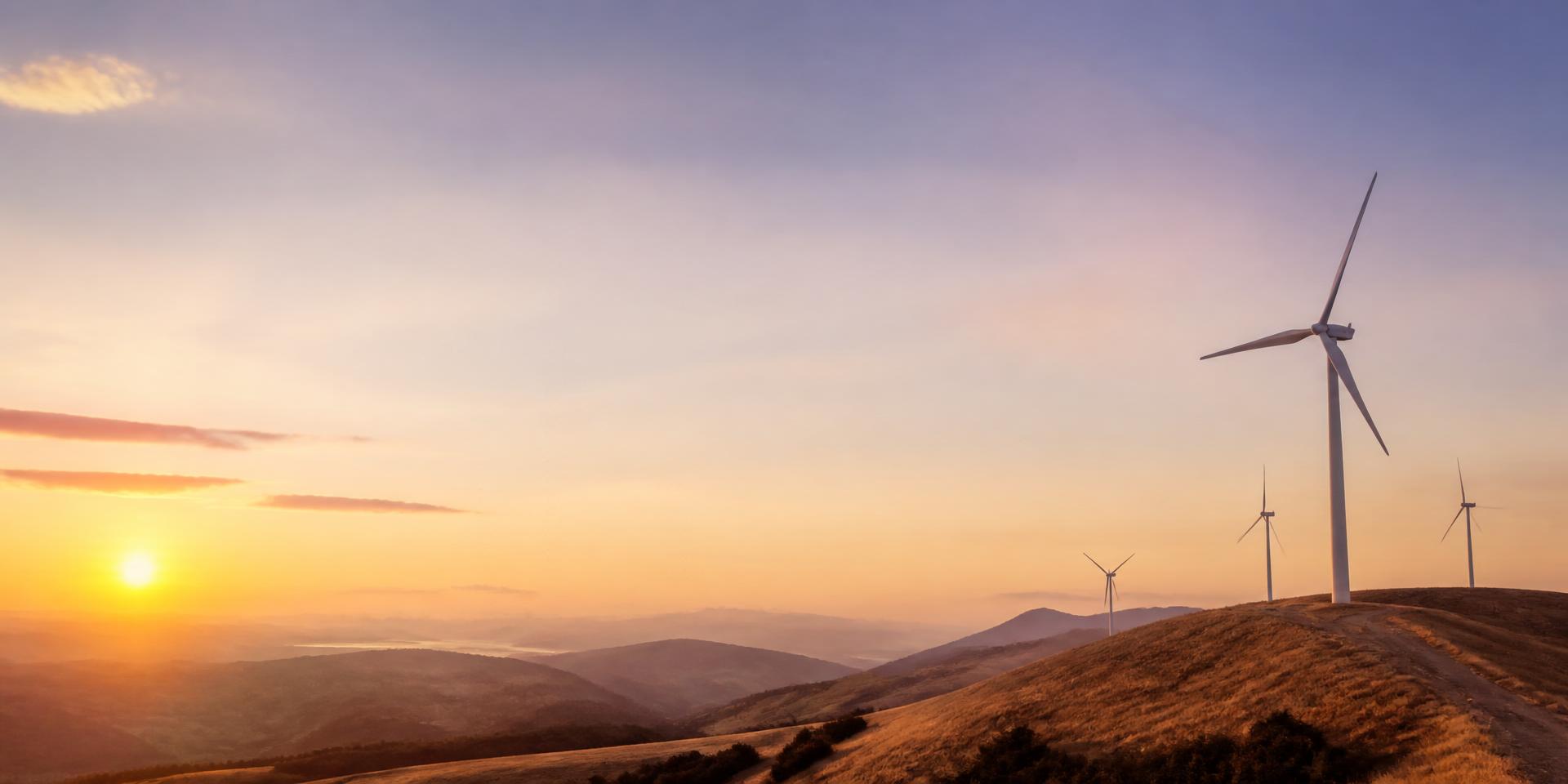 Wind turbines on rolling hills at sunrise
